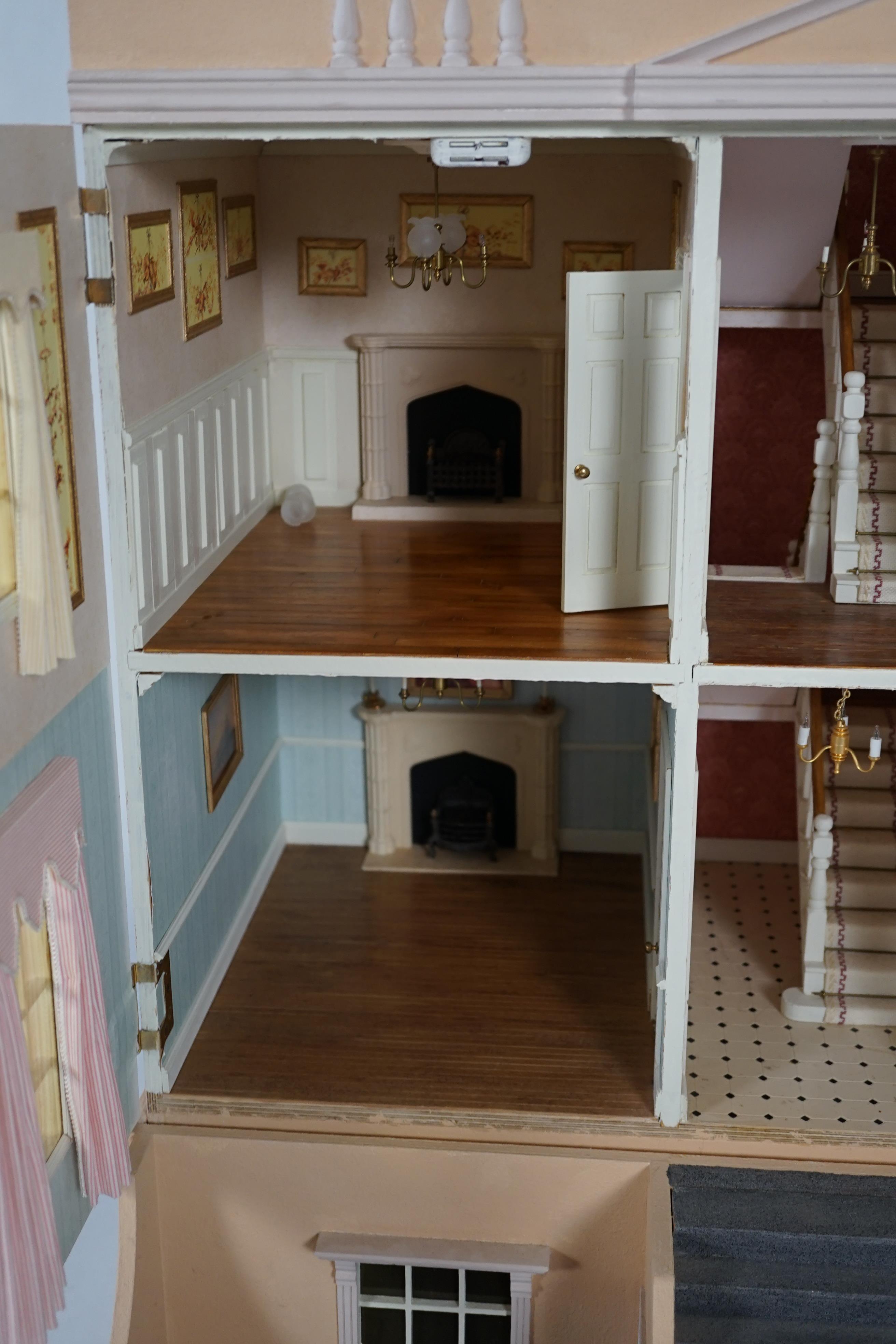 A large modern Georgian style dolls house and extensive contents, with eight fully decorated rooms on four floors, and fitted with electric lighting, removable front steps and pavement section to access basement rooms, 1